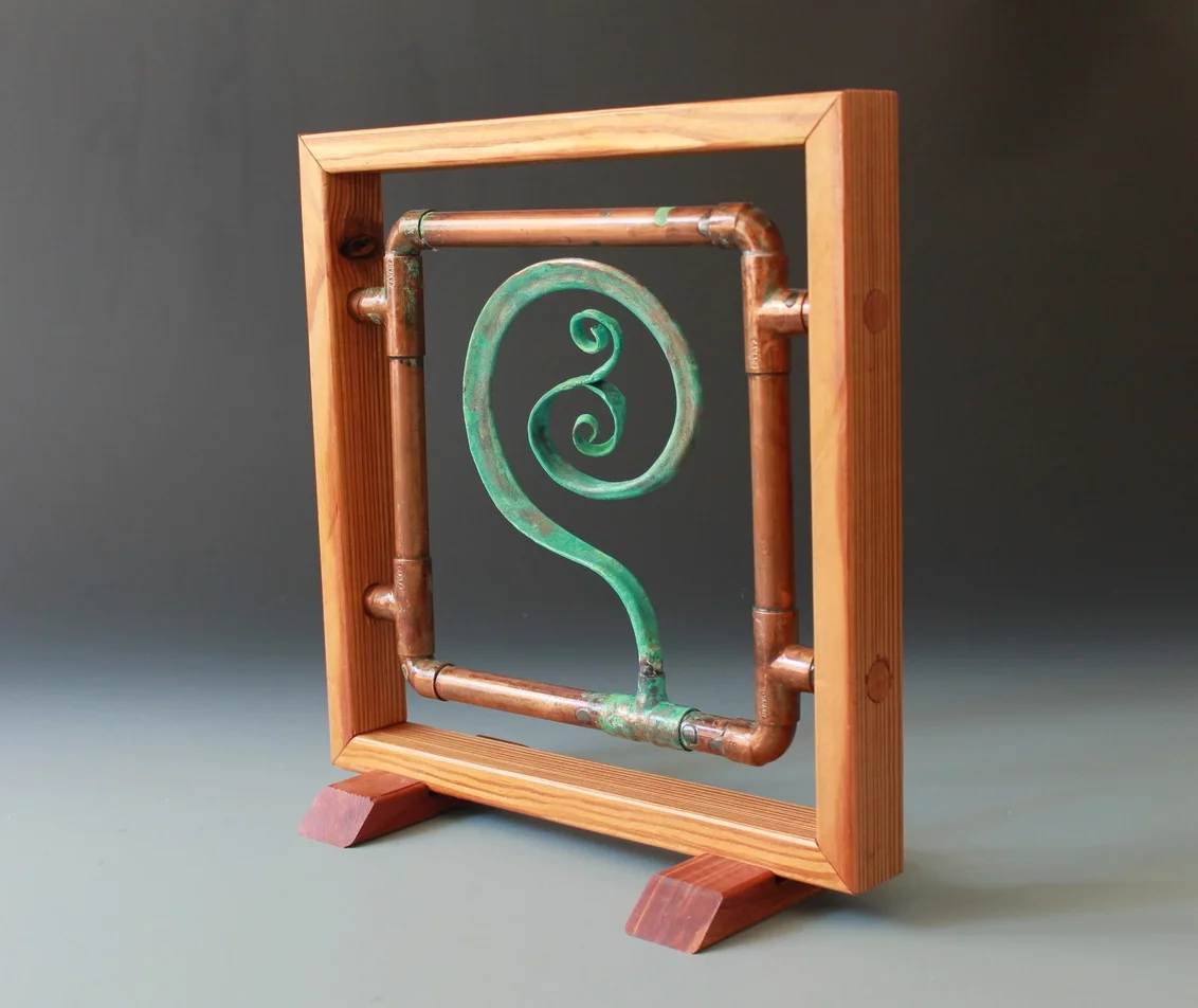Copper spiral panel with reclaimed wooden frame