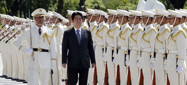 Japanese Prime Minister Shinzo Abe reviews an honor guard in a ceremony prior to his meeting with officers of the Japan Self Defense Forces, on Sept. 12, 2013. (Koji Sasahara/AP)