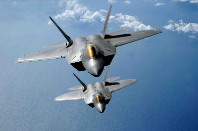 Two F-22 Raptors fly over the Pacific Ocean. (USAF photo by Master Sgt. Kevin J. Gruenwald)