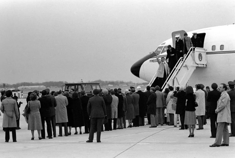 The hostages disembark Freedom One, an Air Force Boeing C-137 Stratoliner aircraft, upon their arrival at the base.