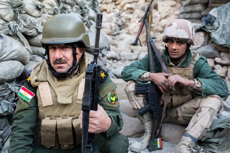Peshmerga fighters take cover behind sandbags in the lines outside Mosul (Photo credit Frederick Paxton/Vice News)