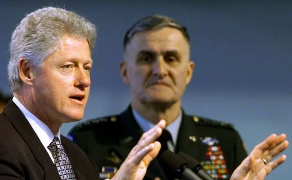 U.S. President Bill Clinton beside Gen. Hugh Shelton, then chairman of the Joint Chiefs of Staff, explaining the U.S. and NATO mission in Kosovo on April 1, 1999. (Win McNamee/Reuters)