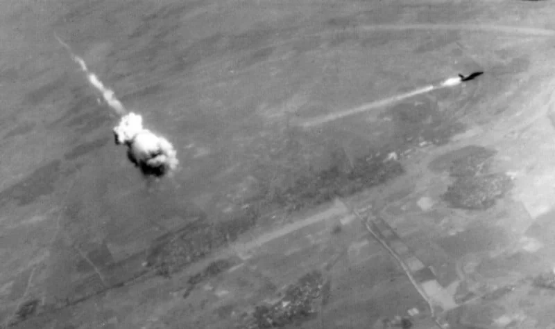 A U.S. Air Force Republic F-105D Thunderchief trailing fire and smoke just after interception by an SA-2 missile on February 14, 1968. The SA-2 did not actually hit the aircraft — instead the warhead was detonated by a command from the tracking radar or by a proximity fuse in the missile when it neared the target, throwing deadly fragments over a wide area. The pilot, Captain Robert Malcolm Elliot, USAF (1929–1968), was killed. His body was not recovered until 1998. (Wikimedia Commons)