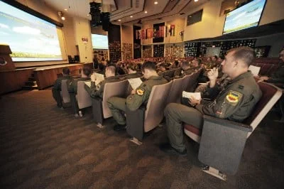 Capt.Taylor Blevins sits in the mass briefing room with approximately 50 other U.S. and allied nation pilots July 16 at Red Flag 09–4 at Nellis Air Force Base, Nev. Mass briefings can last more than an hour and provide pilots with vital information for their simulated combat scenarios. Captain Blevins is assigned to the 77th Fighter Squadron. (U.S. Air Force photo/Tech. Sgt. Michael R. Holzworth)