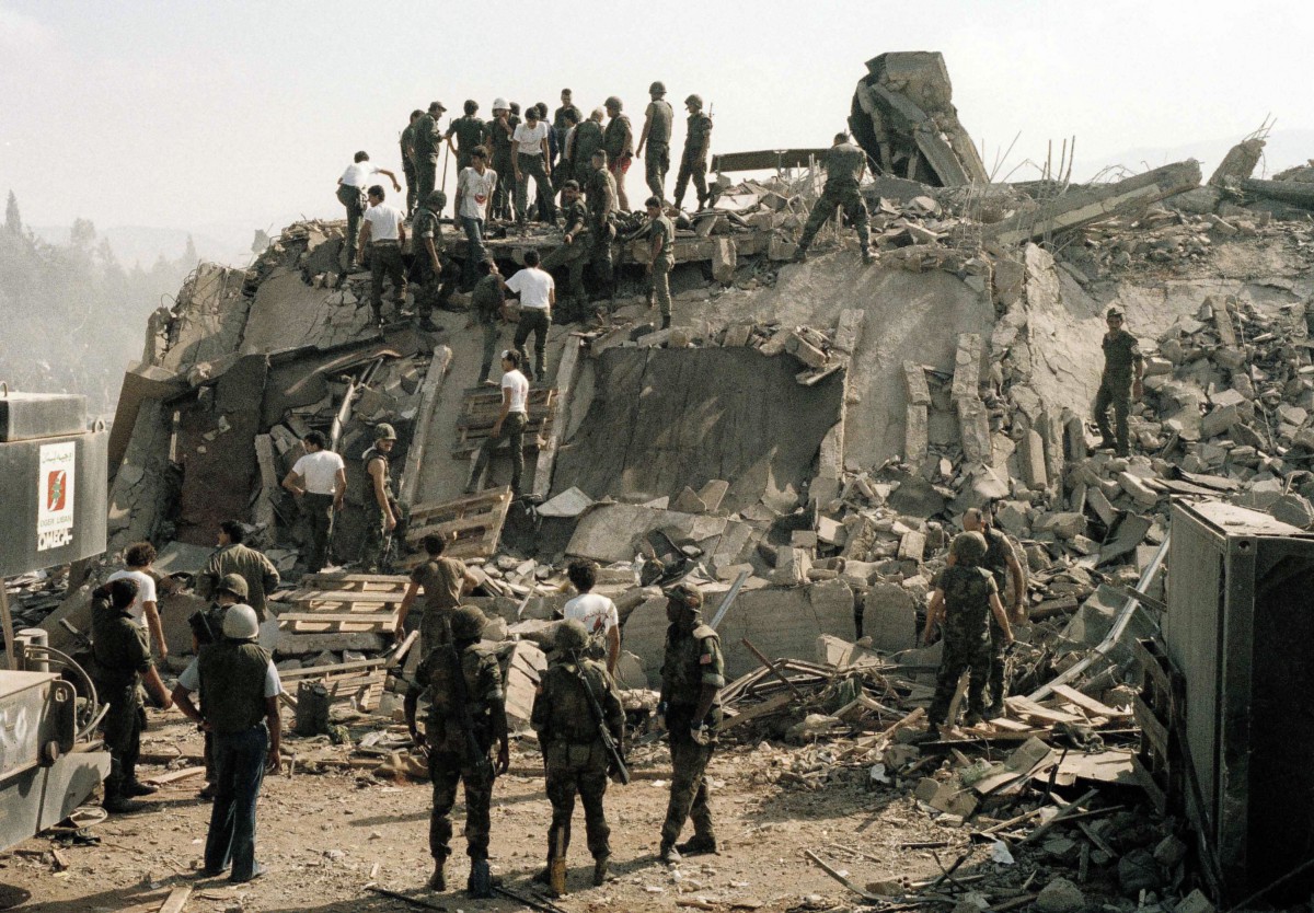 Rescue workers remove the body of a U.S. Marine from the rubble of the Marine Battalion headquarters at the Beirut International Airport on Oct. 23, 1983 (AP)