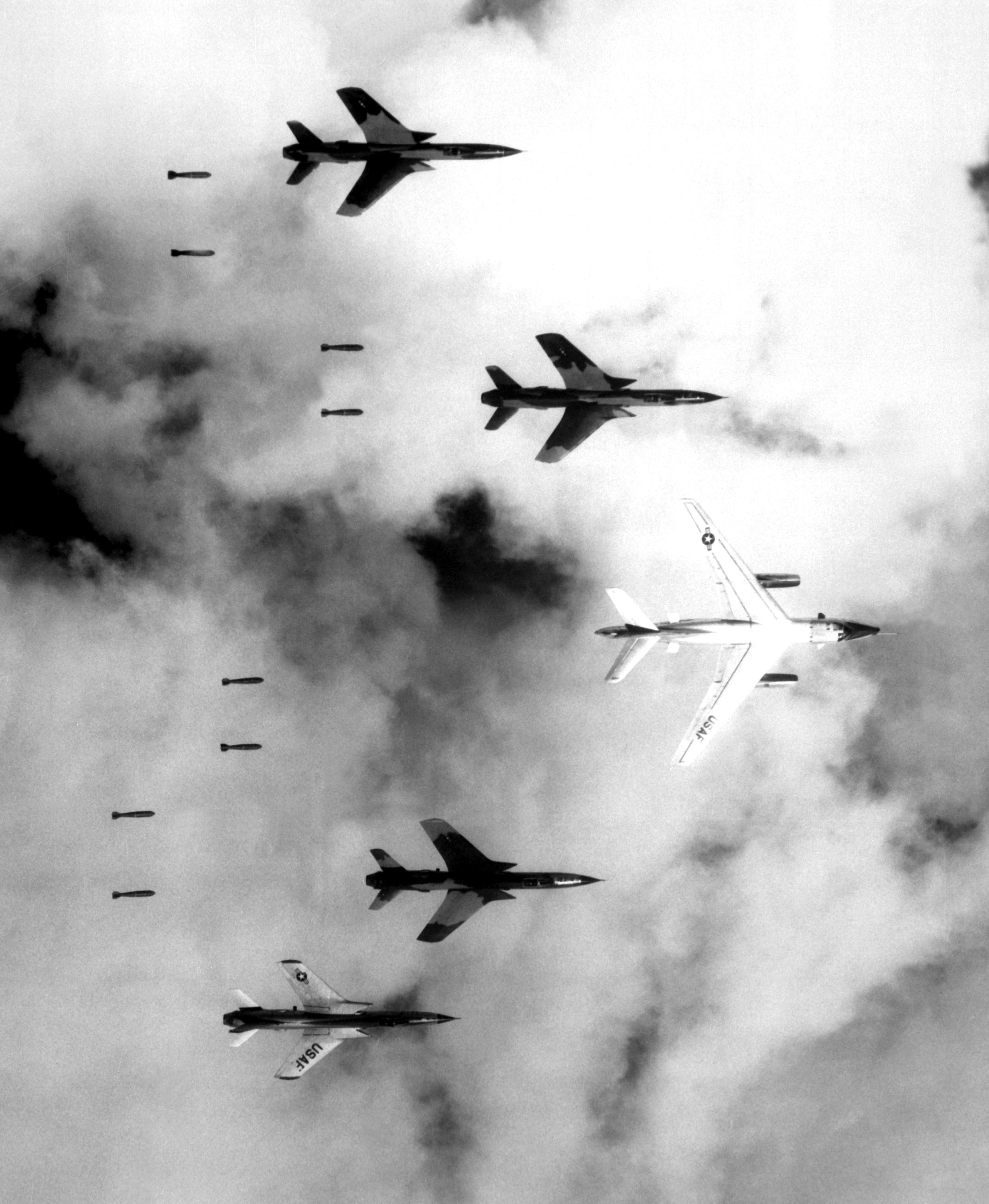 Flying under radar control with a B-66 Destroyer, Air Force F-105 Thunderchief pilots bomb a military target through low clouds over the southern panhandle of North Viet Nam. June 14, 1966. (Cecil J. Poss, Wikimedia Commons)