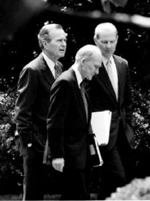President George H.W. Bush speaks with National Security Advisor Brent Scowcroft and Secretary of State James Baker on May 19, 1992 (Photo Credit: David Ake/Getty )