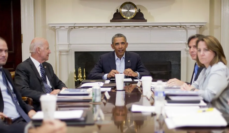 President Barack Obama and Vice President Joe Biden, left, meet with members of the National Security Council, Monday, Aug. 18, 2014, in the Roosevelt Room of the White House in Washington. Also at the meeting, from left are, Deputy National Security Adviser Ben Rhodes, Biden, Obama, Deputy National Security Adviser Tony Blinken, and Homeland Security Adviser Lisa Monaco. (AP Photo/Pablo Martinez Monsivais)