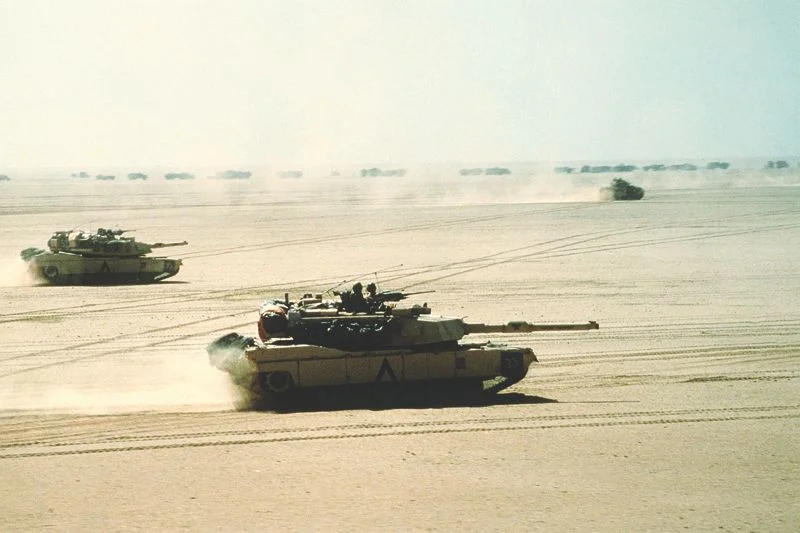 M1A1 Abrams tanks race across the desert on their way to engage the Iraqis. (U.S. Department of Defense photo)