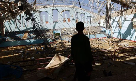 A Yemeni boy inspect the damage at a sports hall that was partially destroyed by Saudi-led air strikes in the Yemeni capital Sanaa on January 19, 2016 ( AFP )