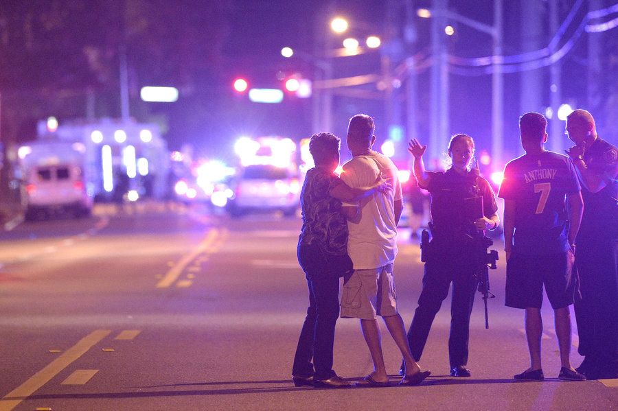 Orlando police officers direct family members away from the Pulse nightclub. (Phelan Ebenhack | AP)