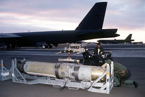 Airmen prepare to load a Mark 60 CAPTOR (encapsulated torpedo) anti-submarine mine onto a B-52G Stratofortress. (U.S. Navy)