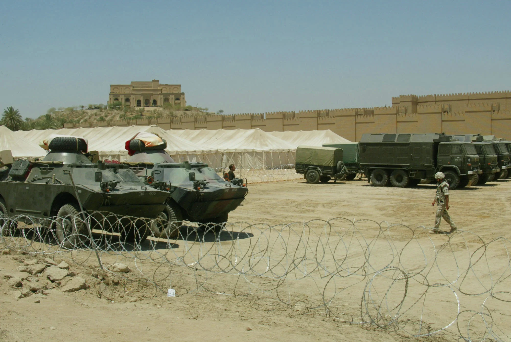 A Polish soldier walks back to his tent just outside the ancient City of Babylon, south of Baghdad, Iraq in 2003. (Bullit Marquez/AP)