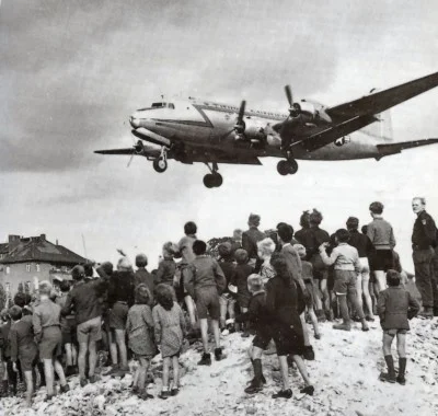 Berliners watching a C-54 land at Berlin Tempelhof Airport, 1948. (Wikimedia Commons)