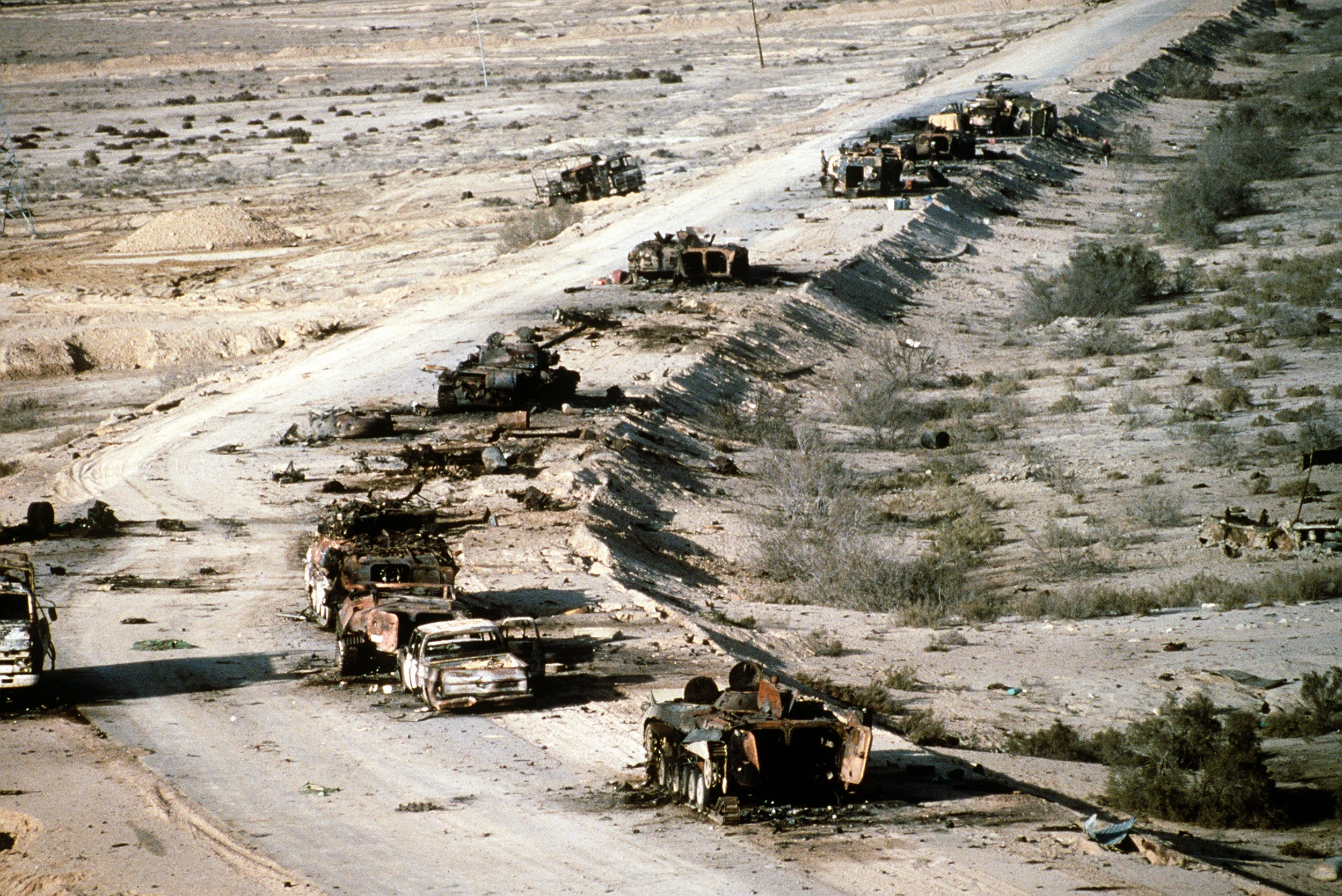A view of Iraqi armored personnel carriers, tanks and trucks destroyed in a Coalition attack along a road in the Euphrates River Valley during Operation Desert Storm, 4 March 1991. (Wagner/DOD Photo)