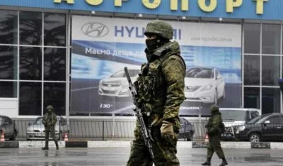 Unidentified armed men patrol outside of Simferopol airport, on February 28, 2014. (Source: AFP PHOTO / VIKTOR DRACHEV)