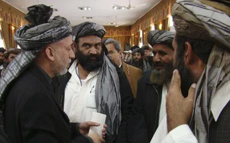 President Hamid Karzai, left, meets local leaders in Lashkar Gah, in Helmand province (AP)
