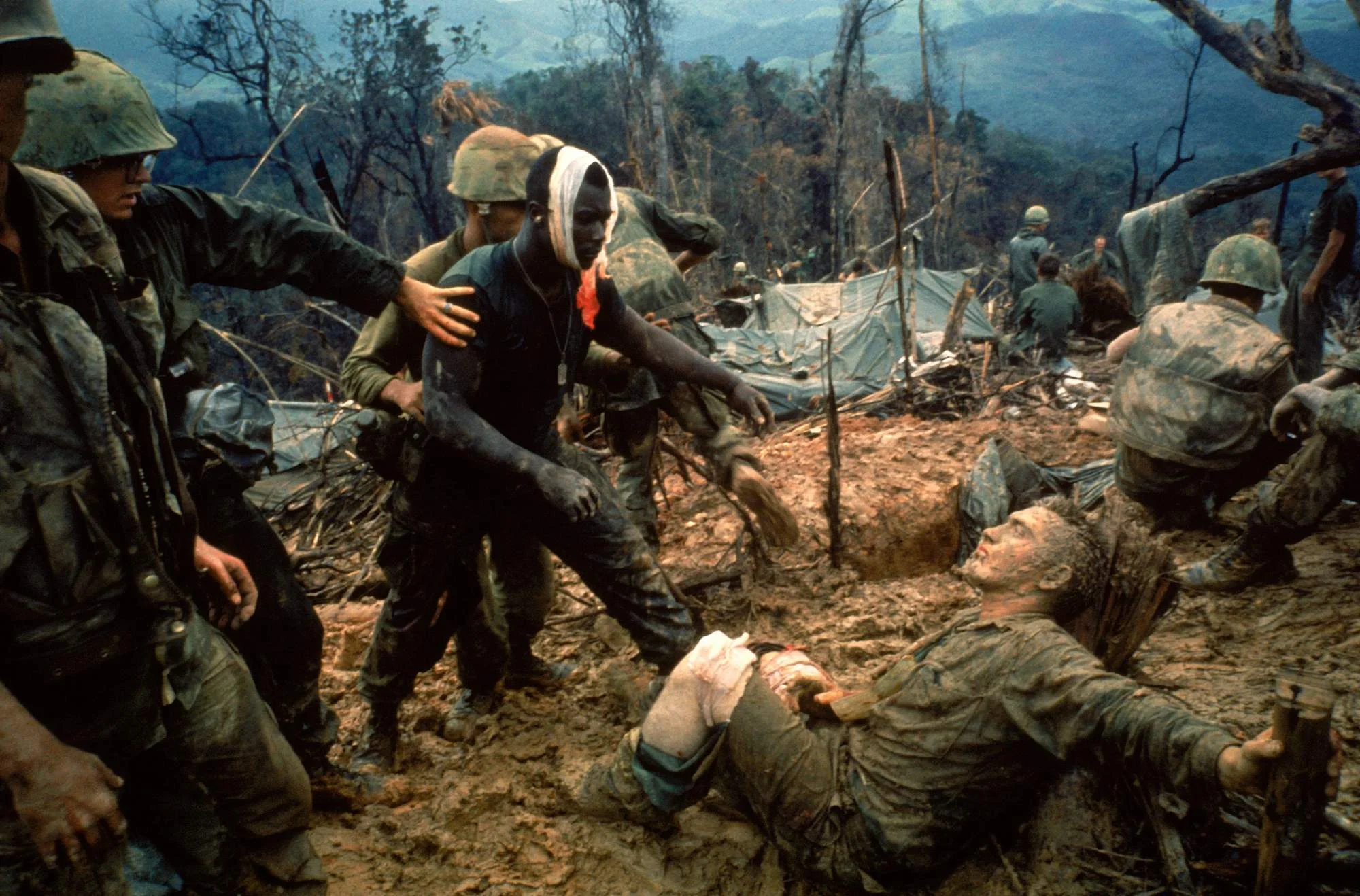 At a First-Aid Center during Operation Prairie: Wounded Marine Gunnery Sgt. Jeremiah Purdie reaching out to a fellow Marine near Hill 484, South Vietnam on October 5, 1966. (Larry Burrows/ George Eastman House )