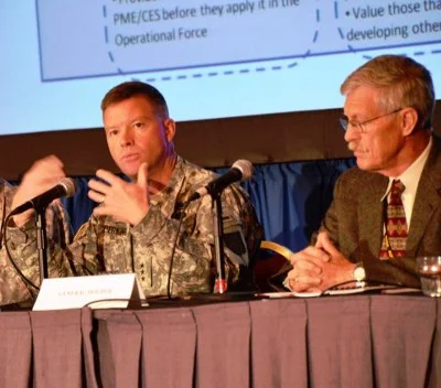 Lieutenant General David G. Perkins (left), commander, Combined Arms Center, Fort Leavenworth, Kan., and retired Lt. Gen. Don Holder, a military consultant, discuss the role of leadership and education in mission command during the Mission Command Symposium in Kansas City, Mo., Jun 18.