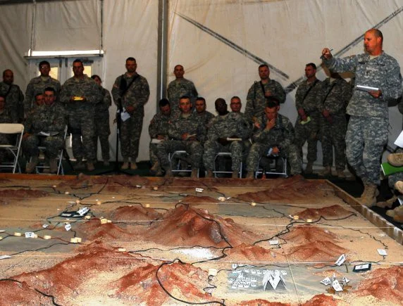Members of the leadership and staff of the New York Army National Guard’s 27th Infantry Brigade Combat Team review the operations plan of the brigade during the unit combined arms rehearsal at Fort Irwin, Calif., Oct. 5, 2011.