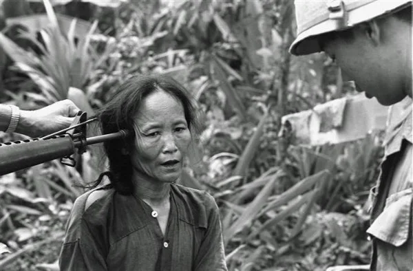 A female Viet Cong suspect is questioned at gunpoint by a South Vietnamese national police officer at Tam Ky, about 350 miles north of Saigon, November 1967. The M-16 rifle was held by a U.S. soldier during an operation of the 101st Airborne Brigade, searching villages of the coastal plains for suspected Viet Cong enclaves. (Via AP/NBCNews)