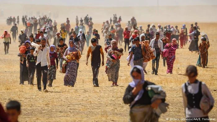 Thousands of Yezidis trapped in the Sinjar mountains as they fled from Islamic State are rescued by Kurdish forces. (E. Yorulmaz/Getty Images)