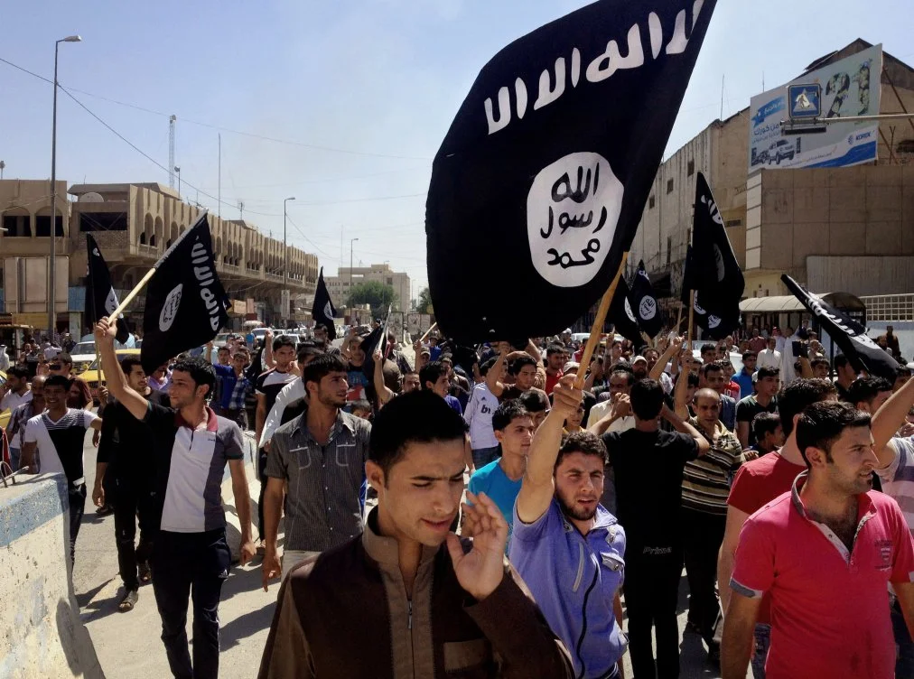 On Monday, June 16, 2014, demonstrators chant pro-Islamic State group slogans as they wave the group's flags in front of the provincial government headquarters in Mosul, 225 miles (360 kilometers) northwest of Baghdad, Iraq. The declaration of a "caliphate" in Iraq and Syria inspired a stream of thousands of foreign fighters to join it and earned it pledges of allegiance by individual militants around the region. (AP Photo)