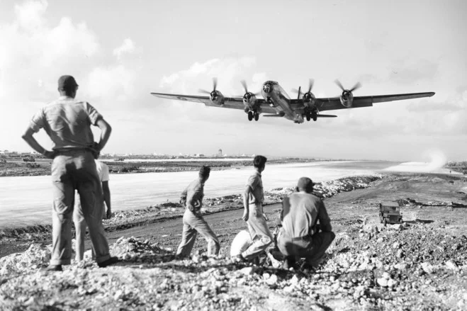 U.S. soldiers at the Saipan air base watched as a B-29 Superfortress took off for an air raid on the Japanese mainland in December 1944. (AP Photo)