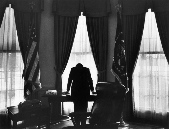 “The Loneliest Job,” a photograph of President John F. Kennedy looking out of the south window of the oval office taken on 10 Feb 1961. (George Tames)