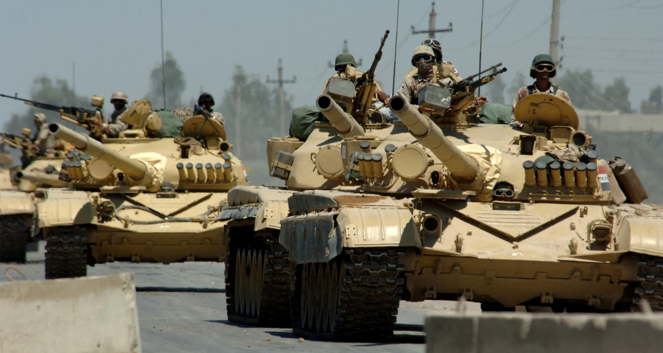 Iraqi tanks assigned to the Iraqi Army 9th Mechanized Division drive through a checkpoint near Forward Operating Base Camp Taji, Iraq. (Michael Larson/U.S. Navy Photo)