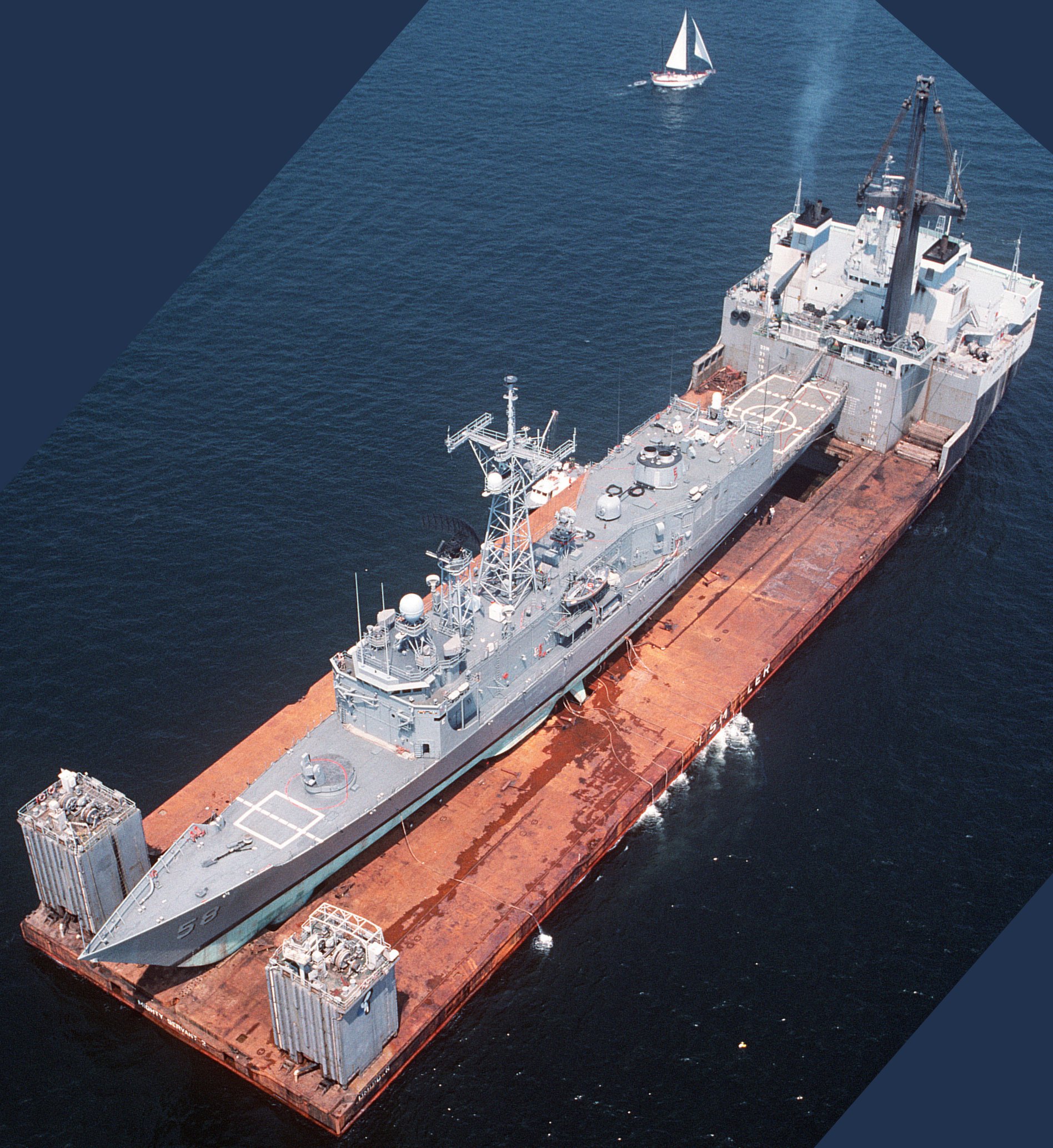 Damaged by a mine in the Persian Gulf, the guided missile frigate USS Samuel B. Roberts is transported by MV Mighty Servant 2 from Dubai to Newport, Rhode Island. (Photographer's Mate 2nd Class D. Kevin Elliott/U.S. Navy Photo)