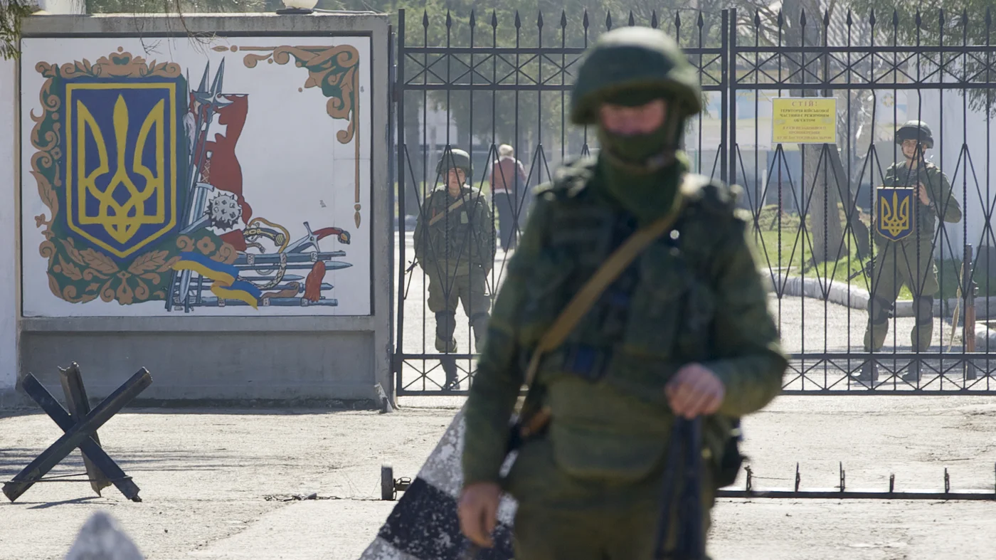 Russian soldiers guard the entrance to the Ukrainian military base in Perevalne, Crimea | Ivan Sekretarev/AP