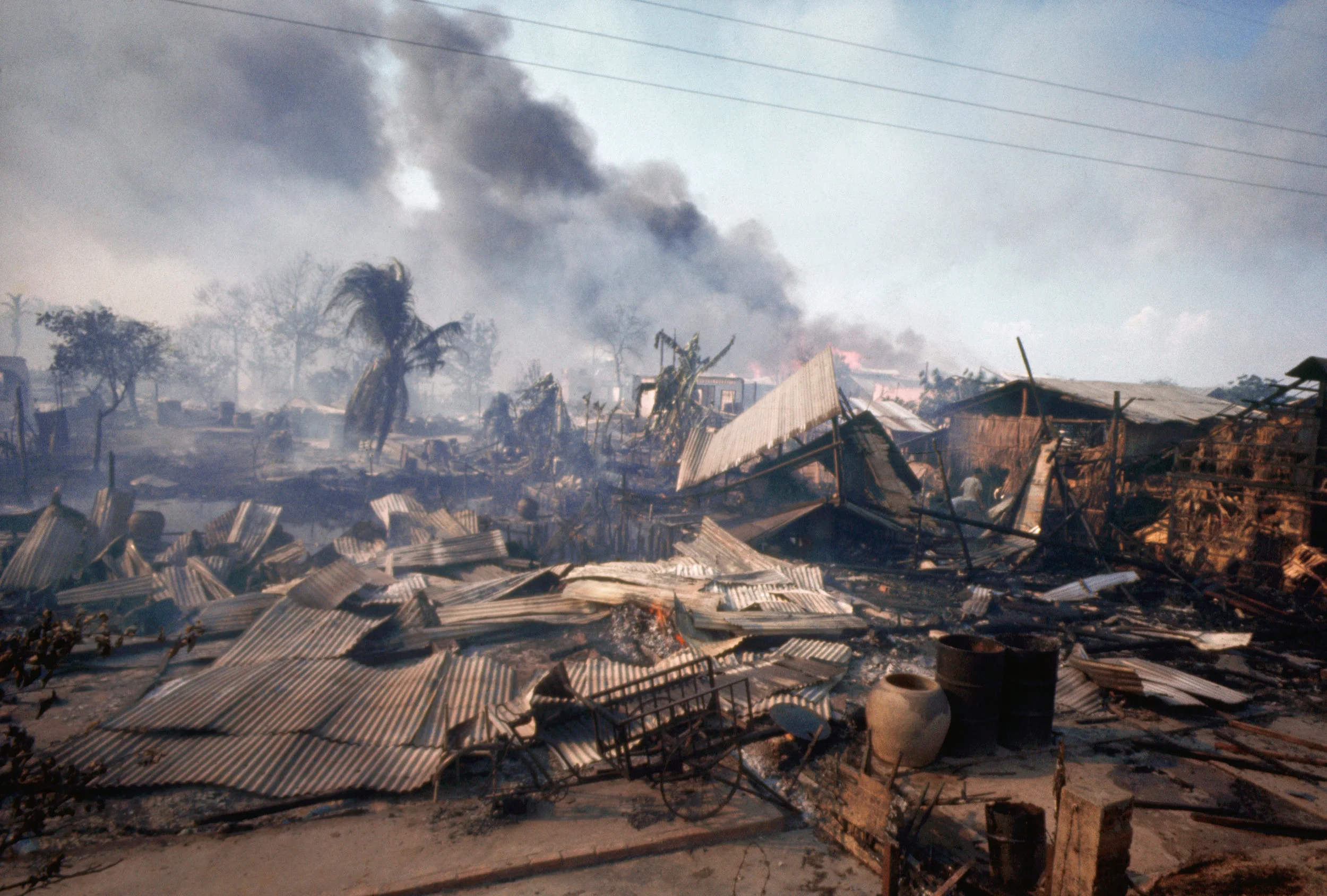 A market in the Cholon District of Saigon is covered in smoke and debris after the Tet Offensive. (History.com)