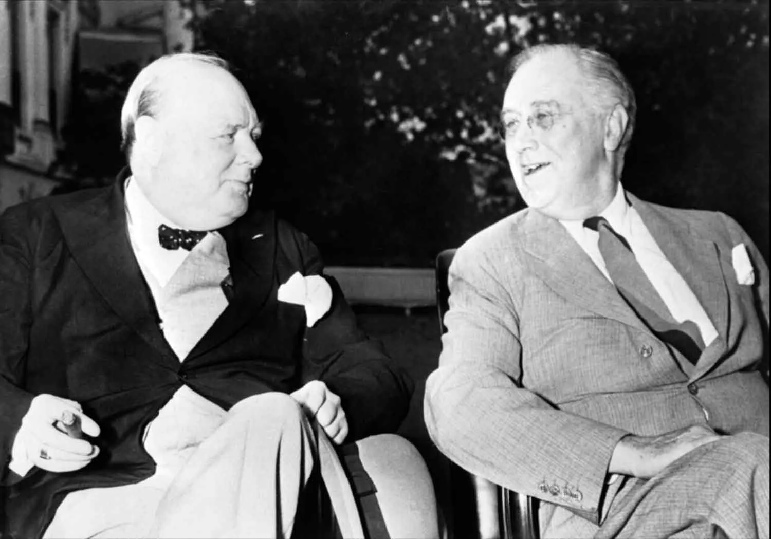 Winston Churchill and Franklin D Roosevelt relax in the grounds of the White House in Washington DC prior to a daily meeting of the joint Chiefs of Staff from the United Kingdom and United States to discuss Allied war strategy. (World War II Today)