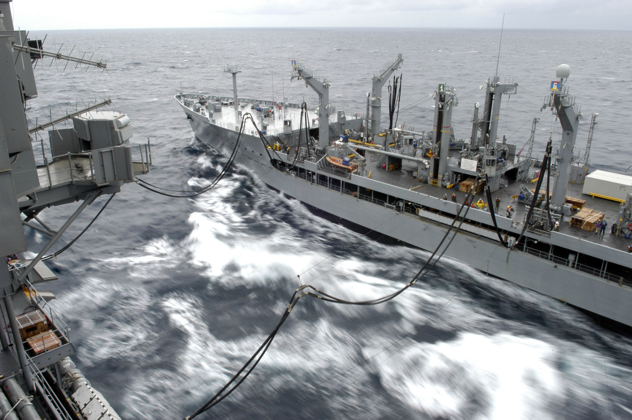 The Underway Replenishment Oilier USNS Yukon (T-AO 202) conducts a replenishment at sea (RAS) with USS Kitty Hawk (CV 63) in 2006. (Photographer's Mate Airman Jimmy C. Pan/U.S. Navy Photo)