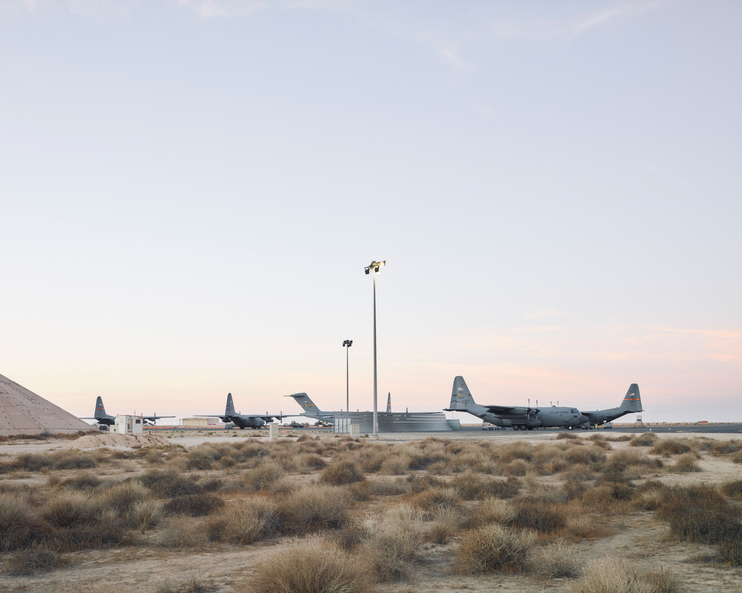   C-17s and C-130s line up on the ramp. (Jason Koxvold)  