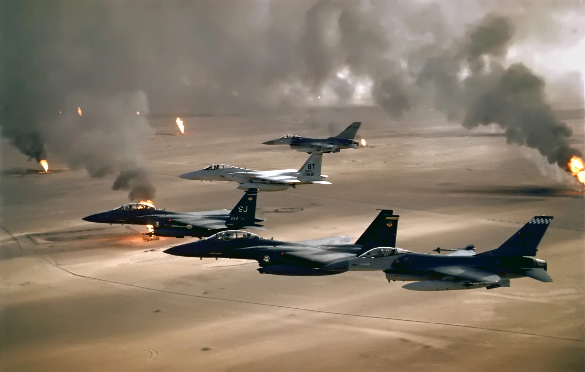 USAF aircraft fly over Kuwaiti oil fires, set by the retreating Iraqi army during Operation Desert Storm in 1991. (USAF Photo/Wikimedia)