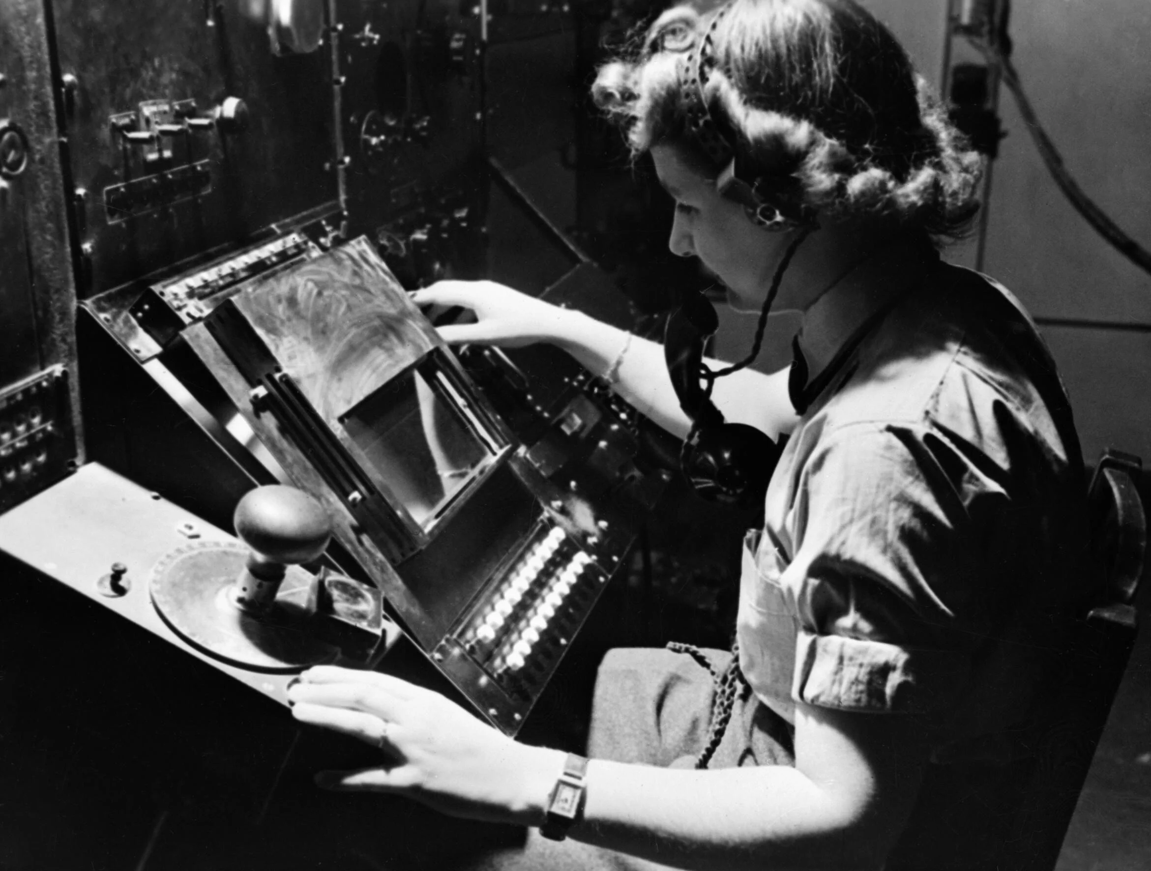Chain Home: WAAF radar operator Denise Miley plotting aircraft on the cathode ray tube of an RF7 Receiver in the Receiver Room at Bawdsey CH. (Wikimedia Commons)