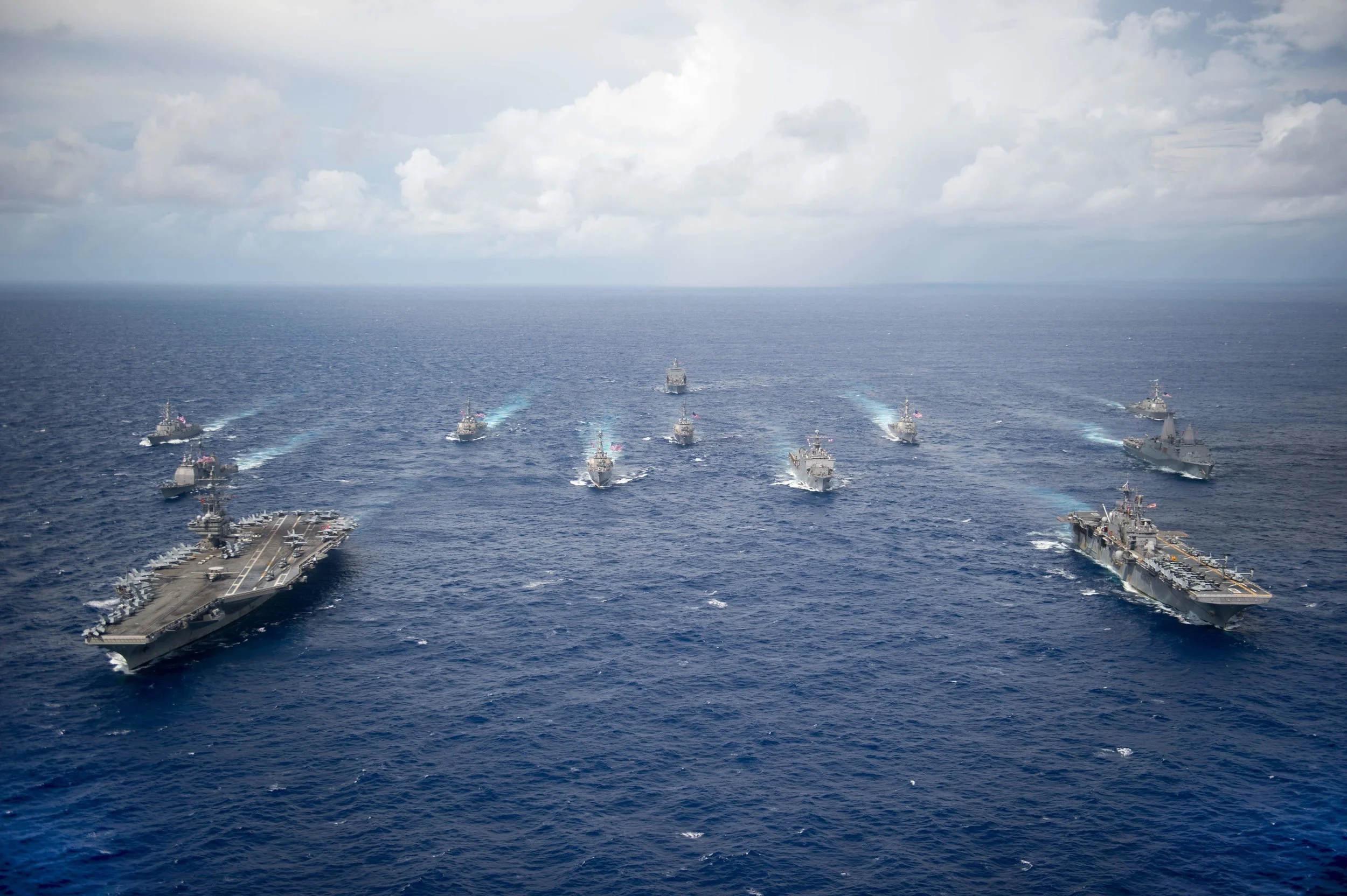 PHILIPPINE SEA (Sept. 23, 2016) USS Ronald Reagan (CVN 76) and USS Bonhomme Richard (LHD 6) lead a formation of Carrier Strike Group Five and Expeditionary Strike Group Seven ships to signify the completion of Valiant Shield 2016. Photo by U.S. Navy photo by Mass Communication Specialist 2nd Class Christian Senyk (Wikimedia)