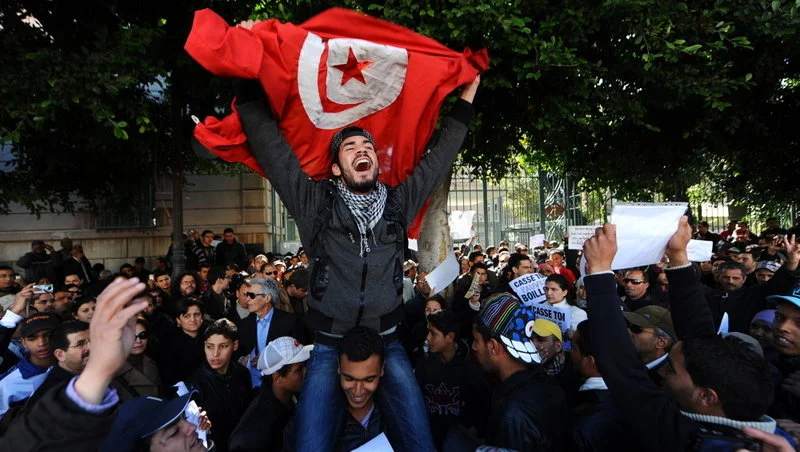 Tunisians protest outside the gates to the French Embassy in Tunis during the Arab Spring. (Fethi Belaid /AFP/Getty Images)