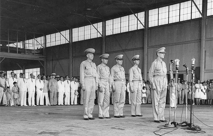 Ceremony at Camp Murphy, Rizal, on 15 August 1941, marking the induction of the Philippine Army Air Corps. Behind Lt. Gen. Douglas MacArthur, from left to right, are Lt. Col. Richard K. Sutherland, Col. Harold H. George, Lt. Col. William F. Marquat, and Maj. LeGrande A. Diller. (Wikimedia)