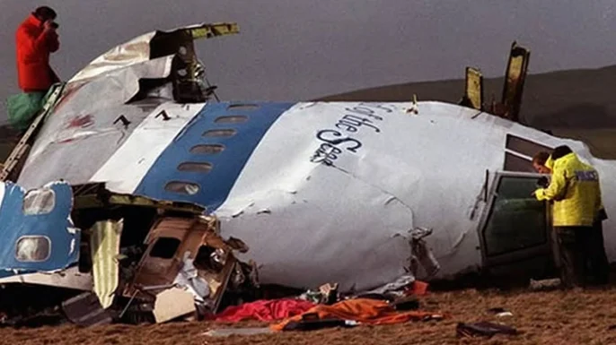Investigators examine the wreckage of Pan Am Flight 103. (History.com)