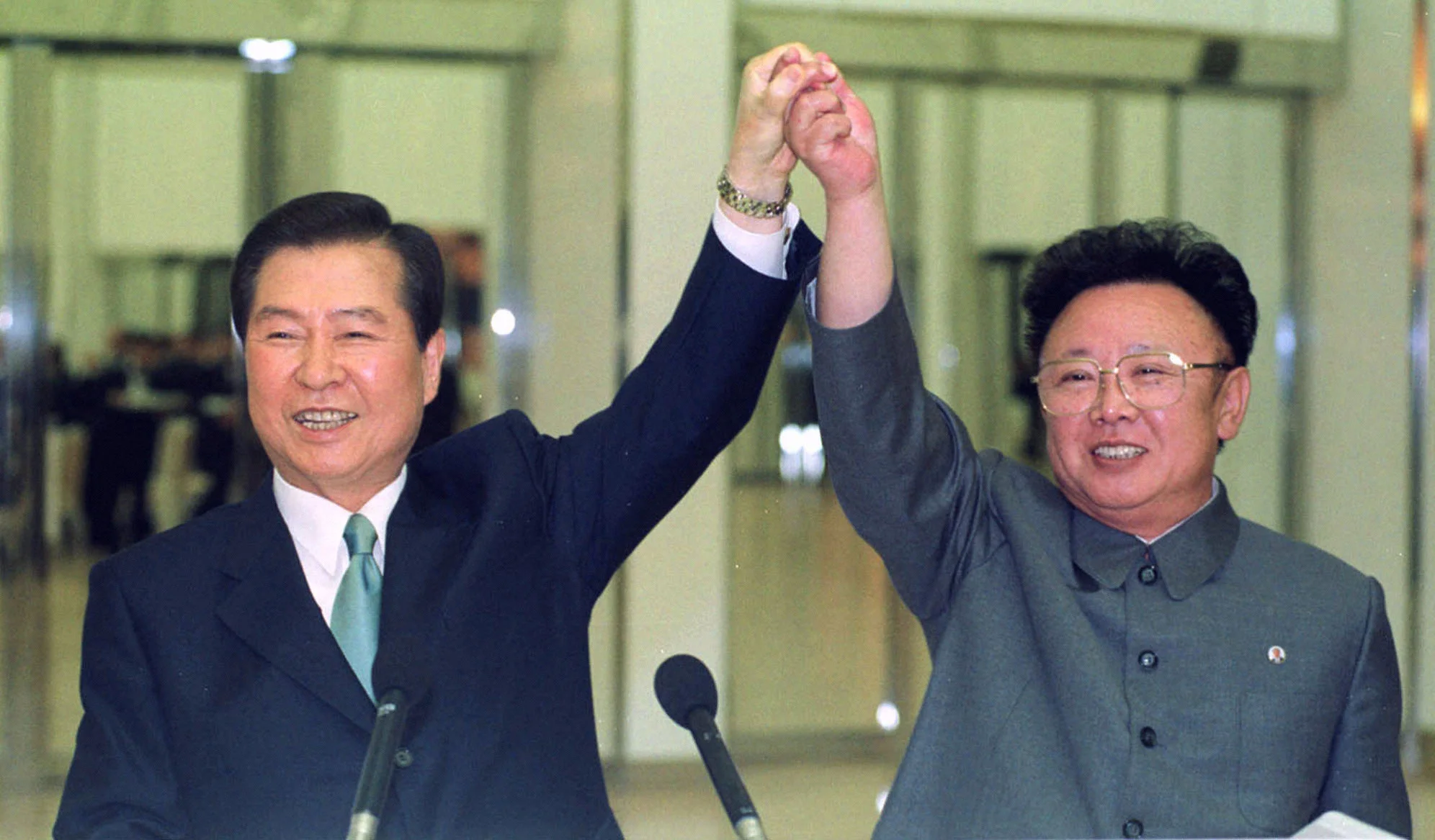 In this June 14, 2000, file photo, South Korean President Kim Dae-jung, left, and North Korean leader Kim Jong II raise their arms together before signing a joint declaration during a summit in Pyongyang, North Korea. The recent inter-Korean summit, the first in more than a decade, followed meetings between Kim Jong Un's father, Kim Jong II, with South Korean presidents in 2007 and 2000. ( Yonhap Pool Photo via AP )