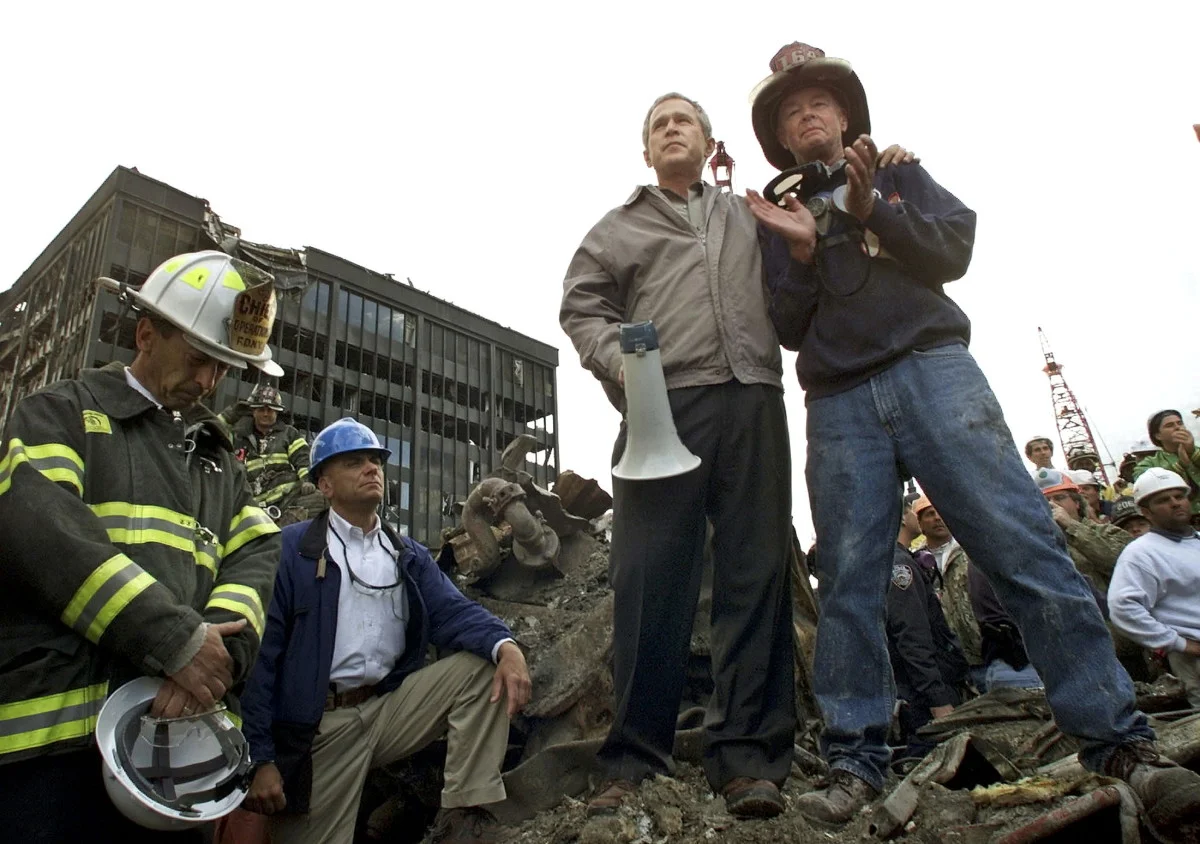 President George Bush with first responders in September 2001 (History.com)