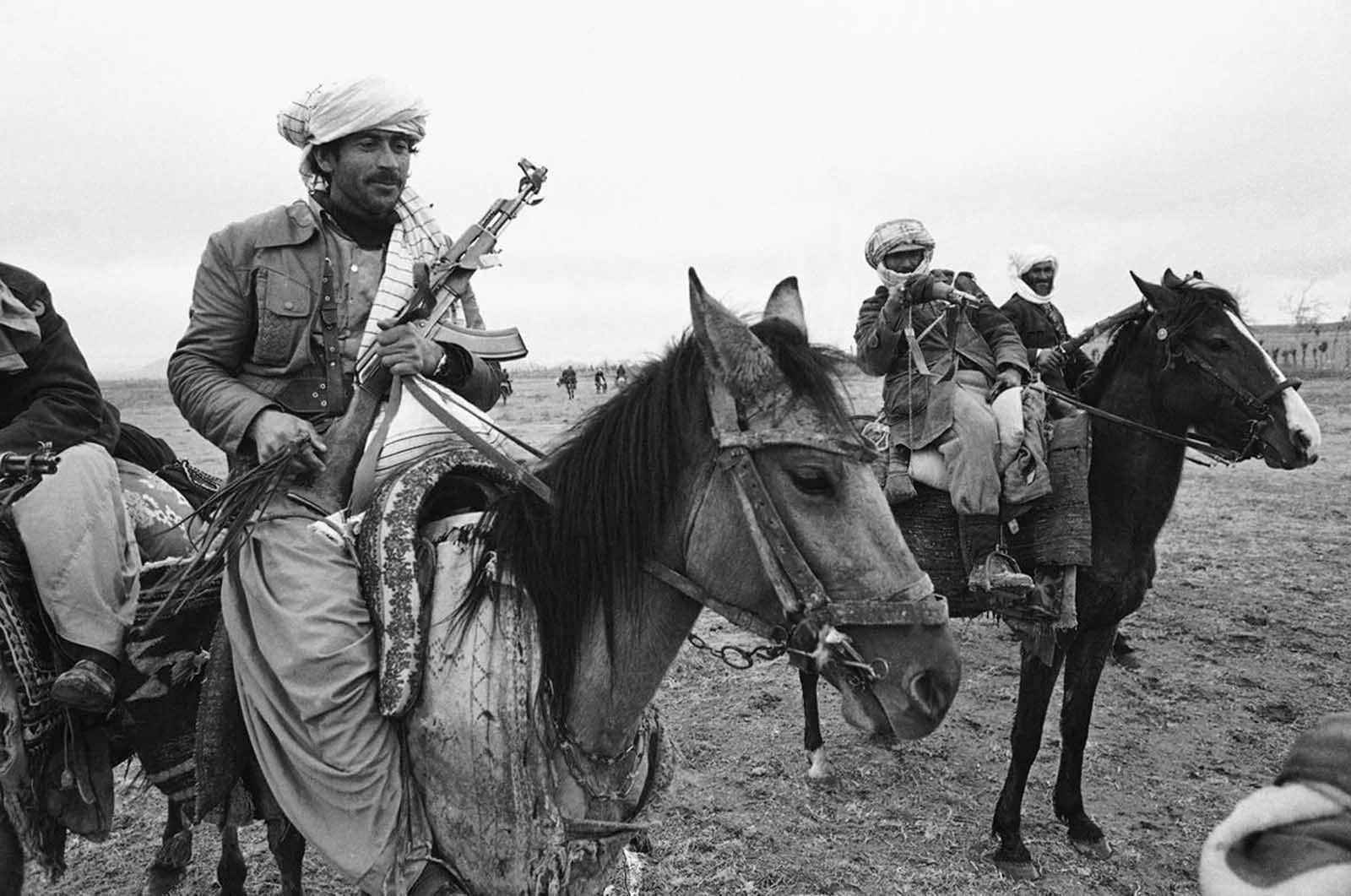 Three Afghan mujahideen, one armed with a Soviet-made AK-47 assault rifle, left, the others with older bolt-action rifles, pose on horseback during a meeting near Herat in 1980. (Rare Historical Photos)