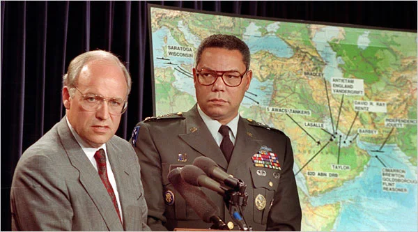 Secretary of Defense Dick Cheney, left, and Colin Powell, the chairman of the Joint Chiefs of Staff, at a Pentagon briefing in August 1990. (Tannen Maury/AP)
