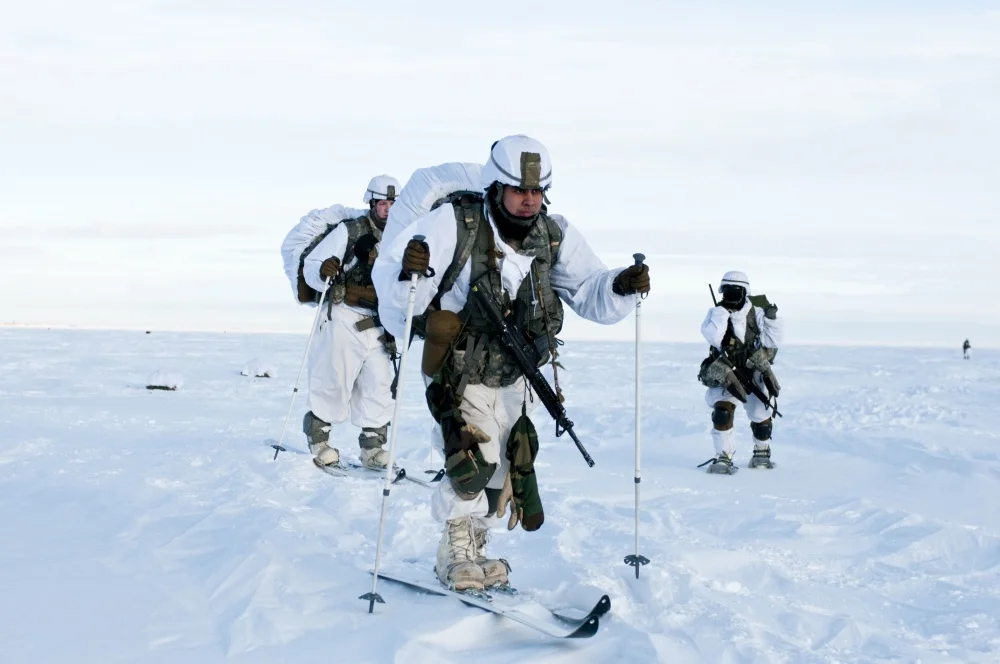 Paratroopers with U.S. Army Alaska’s 4th Infantry Brigade Combat Team (Airborne), 25th Infantry Division ski across the drop zone during Exercise Spartan Pegasus. The extremely cold demonstration in airborne operations and arctic mobility took place in one of the northern-most territories of Alaska, well north of the Earth’s Arctic Circle. (SSG Daniel Love/U.S. Army Photo)