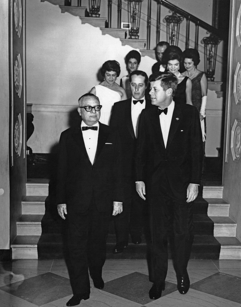   President John F. Kennedy, First Lady Jacqueline Kennedy, and others arrive at the Entrance Hall of the White House for a dinner in honor of President of Venezuela, Rómulo Betancourt, and First Lady of Venezuela, Carmen Valverde de Betancourt in 19