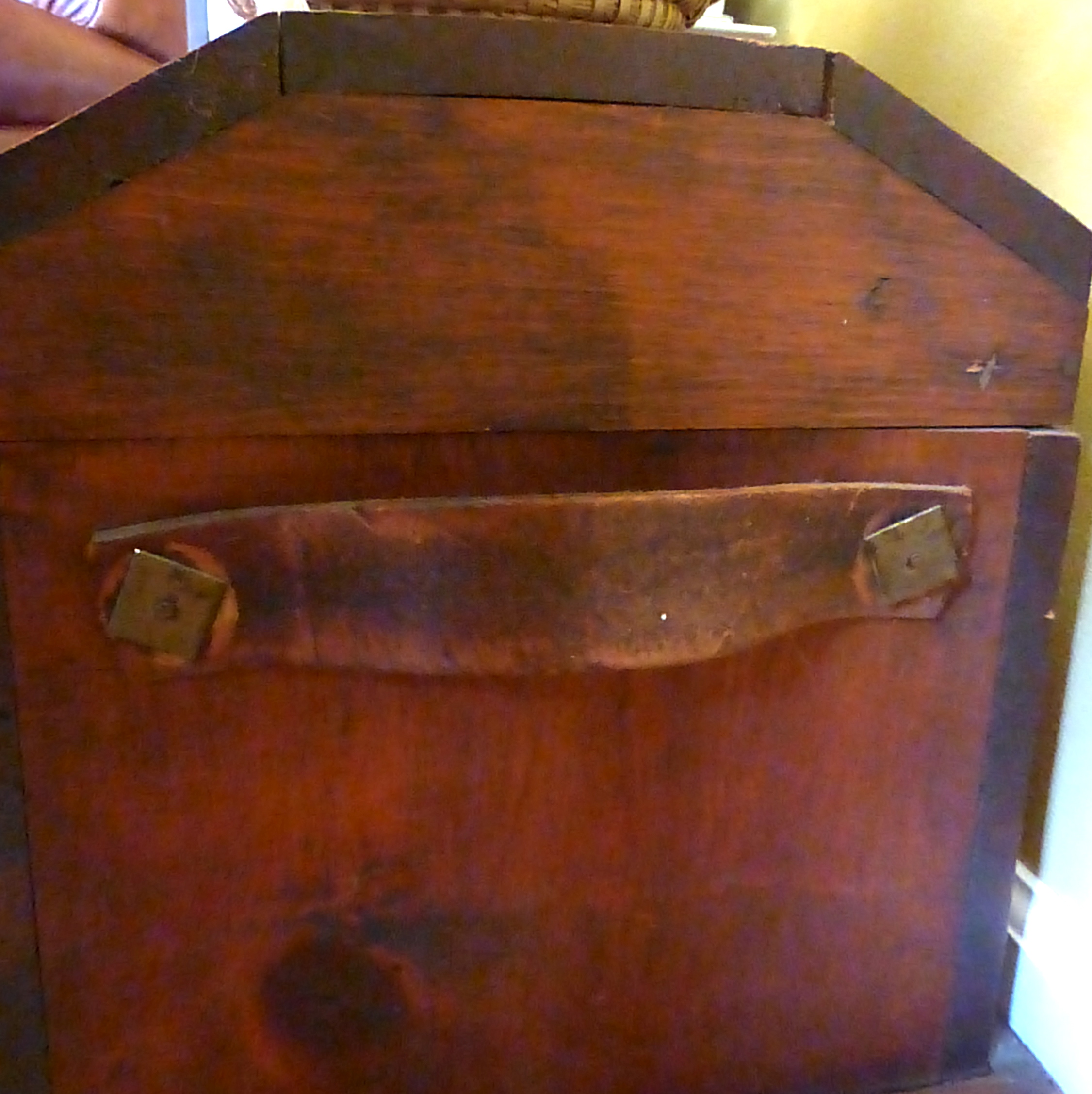 The leather straps and metal braces add to the character of this piece.