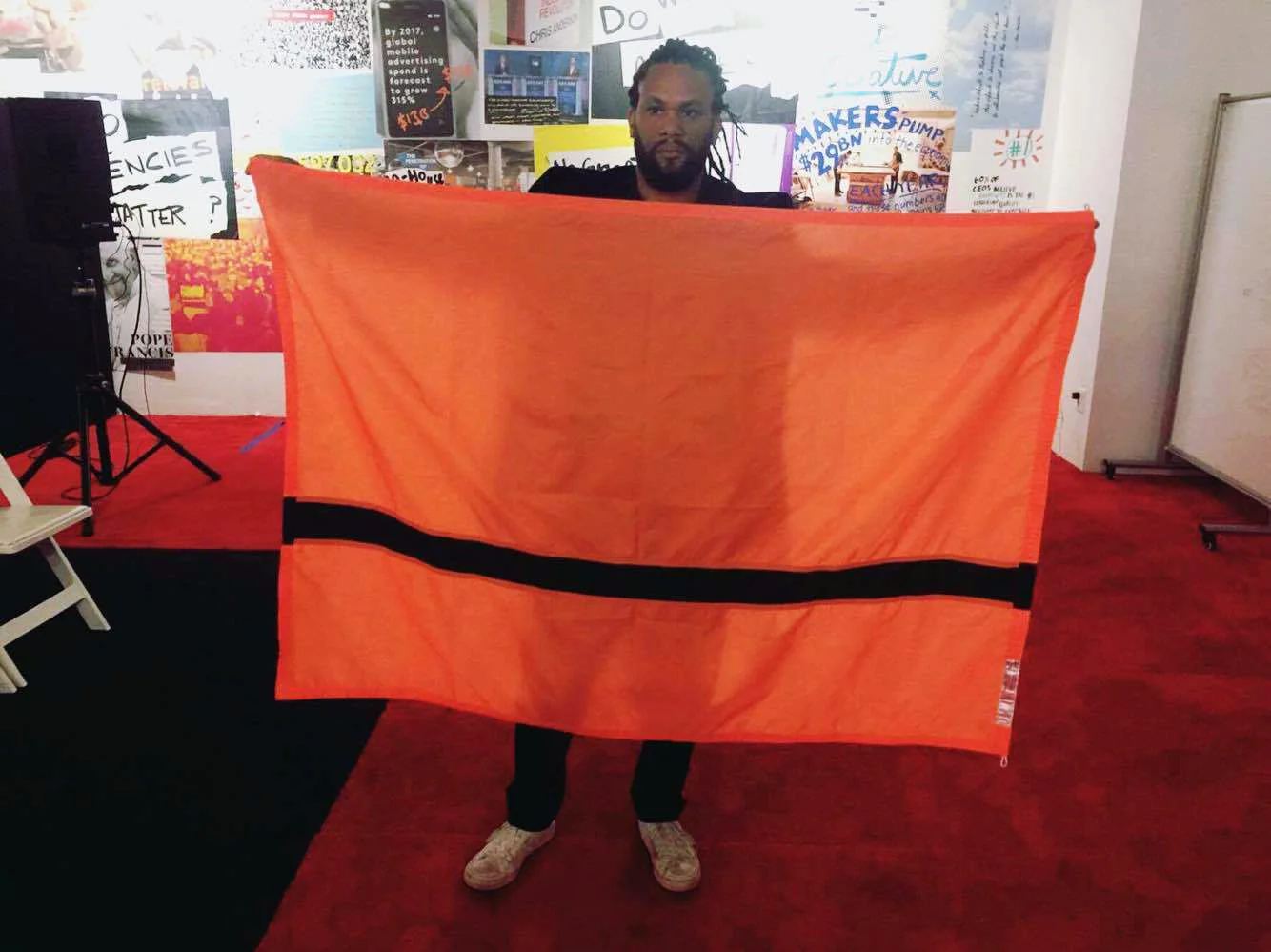 Franklin Leonard, hollywood influencer, film executive and founder of the Black List striking a pose with the Refugee Nation's flag.